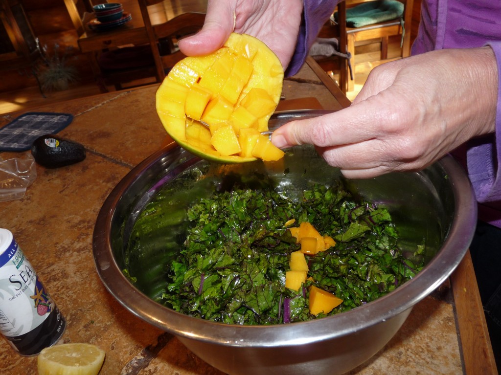 Take a grapefruit spoon and remove the diced mango from the skin, and add to salad. 